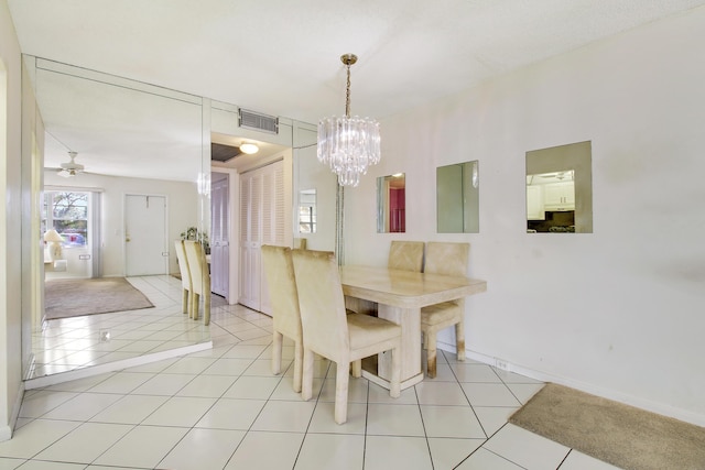 unfurnished dining area with light tile patterned floors and ceiling fan with notable chandelier