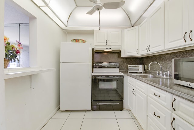 kitchen featuring light tile patterned floors, sink, white cabinetry, white refrigerator, and black / electric stove