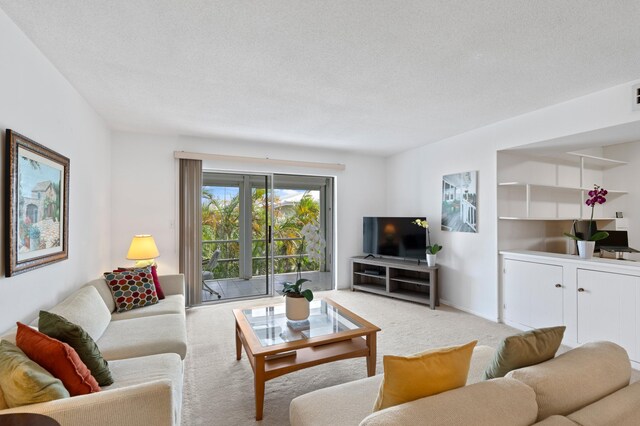 home office with light carpet and a textured ceiling