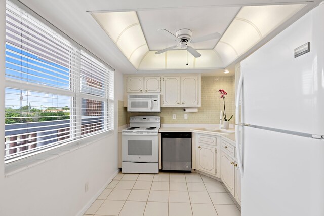 kitchen featuring tasteful backsplash, sink, light tile patterned floors, ceiling fan, and white appliances