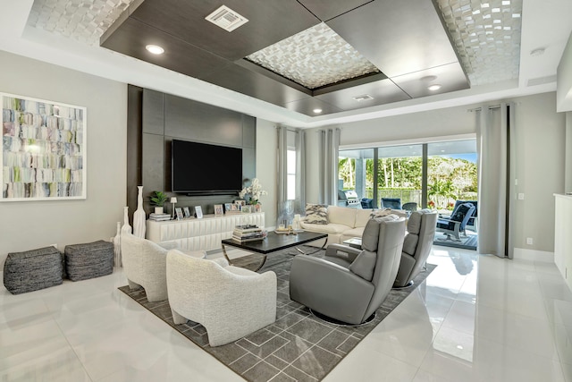 living room featuring light tile patterned floors and a tray ceiling