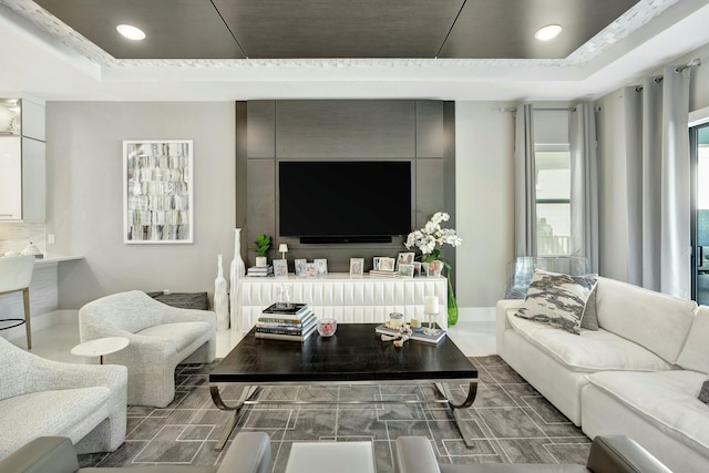 living room featuring a tray ceiling