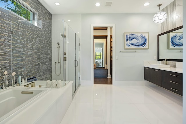 bathroom featuring tile patterned flooring, vanity, plenty of natural light, and separate shower and tub