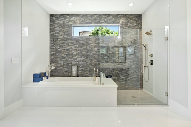 bathroom with tile patterned flooring and separate shower and tub