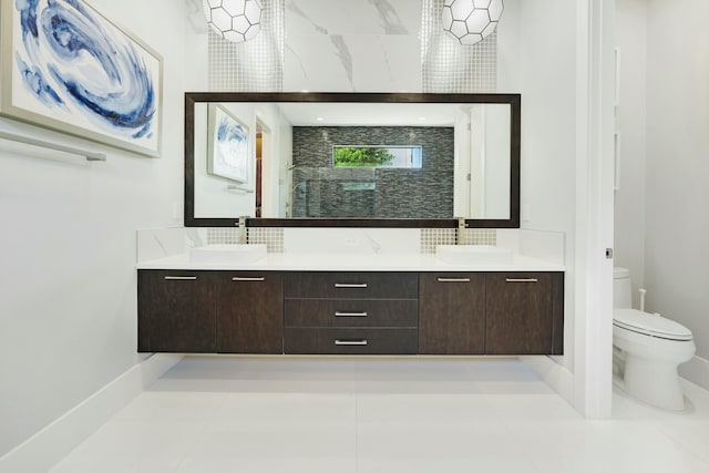 bathroom with tile patterned floors, vanity, and toilet