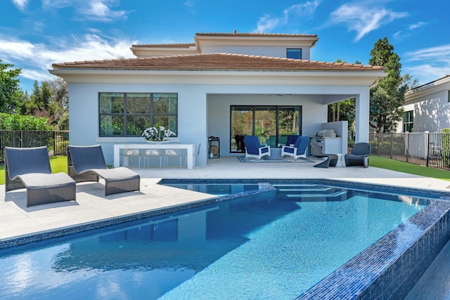 5525 Renoir Pl, Palm Beach Gardens, FL 33418 - back of house featuring a tiled roof, fence, a pool with connected hot tub, a patio, and stucco siding