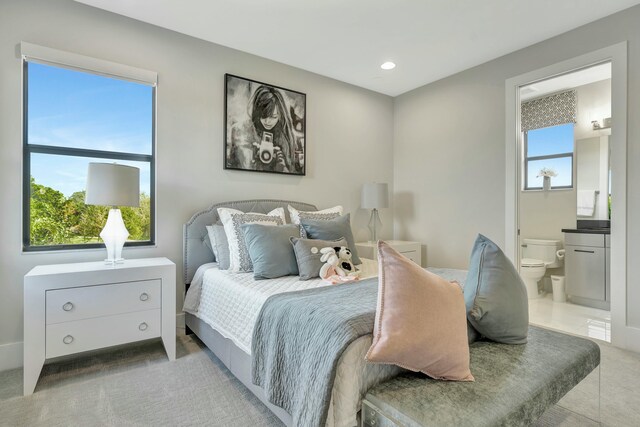 bedroom featuring carpet flooring and ensuite bath