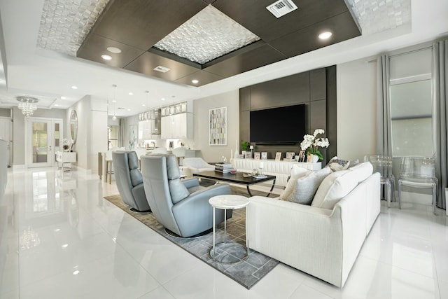 living room featuring a raised ceiling and french doors