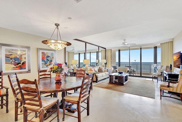 dining space with expansive windows and ceiling fan with notable chandelier