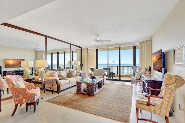 living room with ceiling fan, floor to ceiling windows, and a textured ceiling