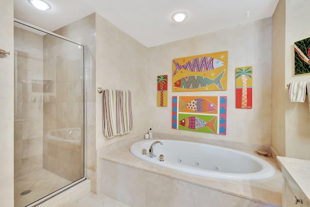 bathroom featuring plus walk in shower, vanity, and tile patterned floors