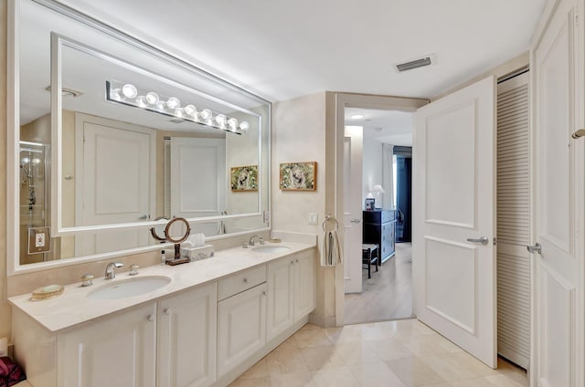 bathroom featuring tile patterned flooring and vanity