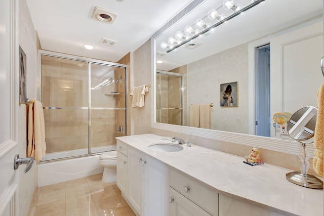 full bathroom featuring enclosed tub / shower combo, vanity, tile patterned floors, and toilet