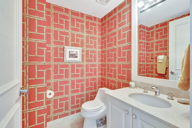 bathroom featuring tile patterned flooring, vanity, and toilet