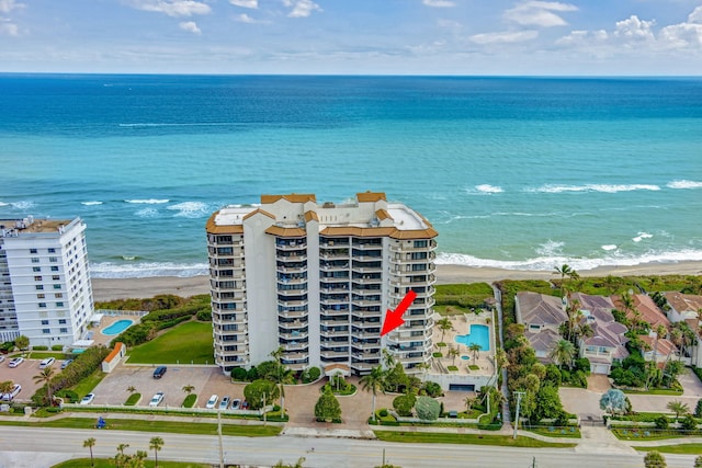 bird's eye view with a water view and a beach view