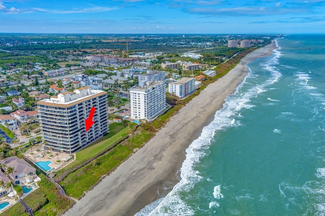 drone / aerial view featuring a view of the beach and a water view