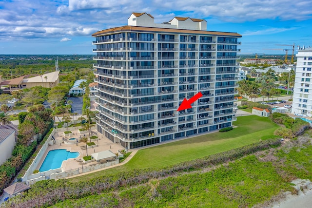 view of building exterior featuring a community pool