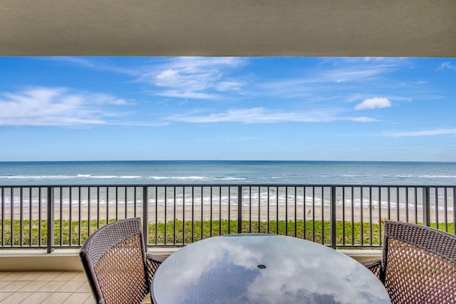 balcony with a beach view and a water view