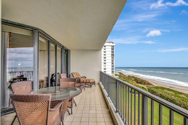 balcony featuring a beach view and a water view