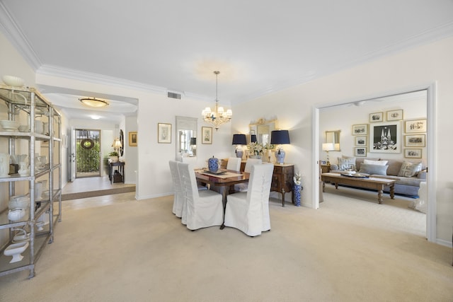 carpeted dining room featuring a notable chandelier and crown molding