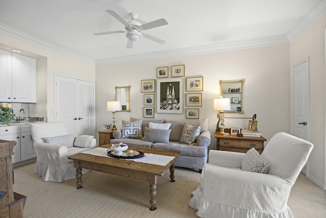 carpeted living room with crown molding, sink, and ceiling fan