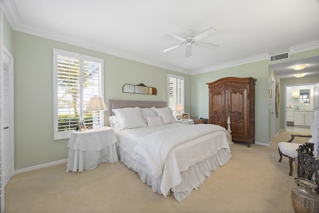 carpeted bedroom featuring ornamental molding, ensuite bath, ceiling fan, and a closet