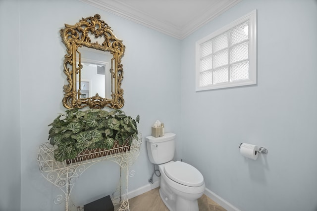 bathroom with crown molding, tile patterned floors, and toilet