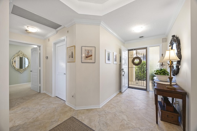 entryway featuring ornamental molding and a textured ceiling