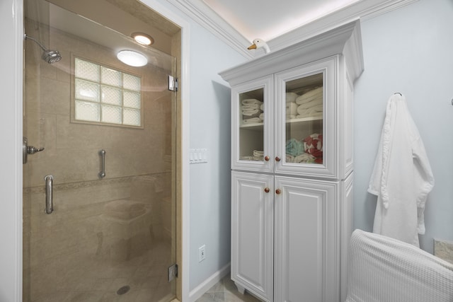 bathroom featuring ornamental molding and a shower with door