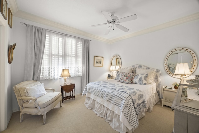 bedroom featuring ornamental molding, light colored carpet, and ceiling fan