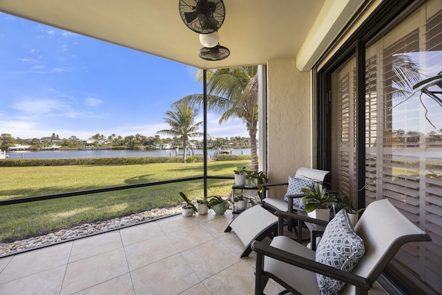 unfurnished sunroom featuring a water view