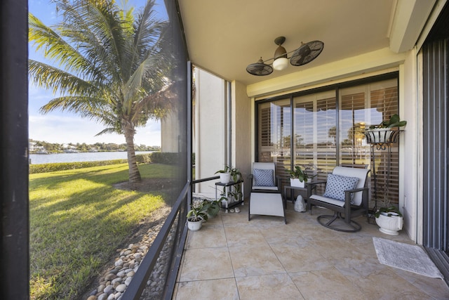 sunroom / solarium featuring a water view