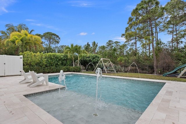 view of swimming pool with a patio, fence, and a fenced in pool