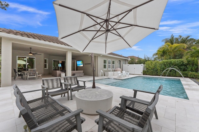 view of swimming pool with a fenced in pool, outdoor lounge area, a patio area, a ceiling fan, and a gate