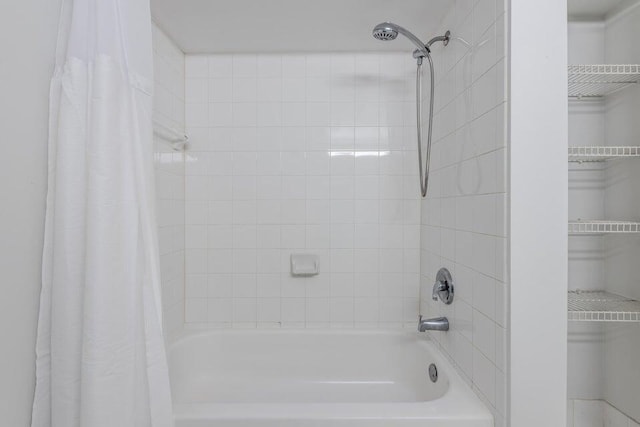 bathroom with shower / bath combination with curtain