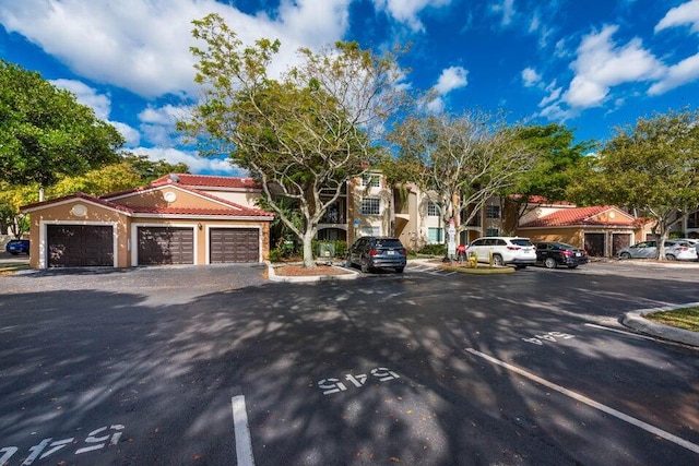 view of front of home featuring a tile roof and uncovered parking