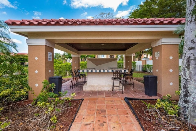 view of patio with a gazebo and an outdoor bar