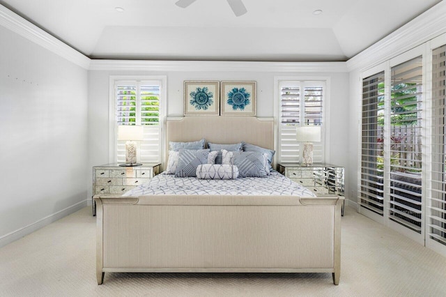 carpeted bedroom with ceiling fan, ornamental molding, and lofted ceiling