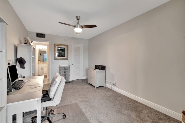 carpeted office space with ceiling fan