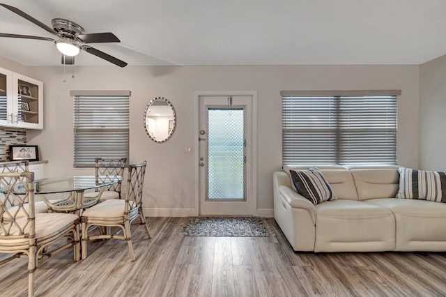 living room with hardwood / wood-style flooring and ceiling fan