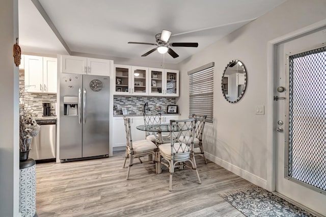 dining area featuring ceiling fan and light wood-type flooring