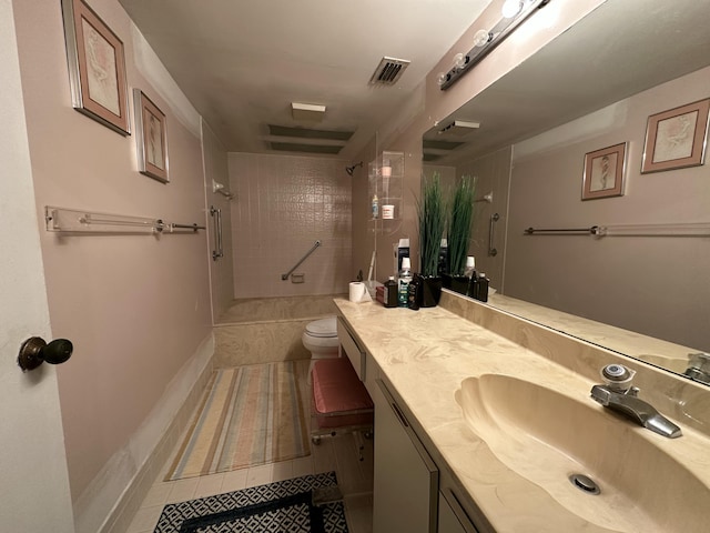 full bathroom featuring toilet, tile patterned flooring, tiled shower / bath, and vanity