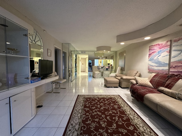 living room featuring a textured ceiling and light tile patterned floors