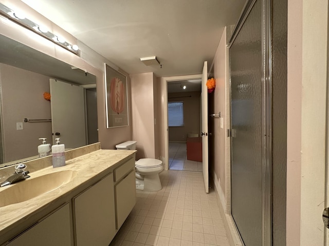 bathroom with tile patterned floors, vanity, toilet, and walk in shower