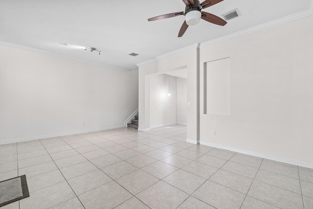 tiled spare room featuring ceiling fan and ornamental molding