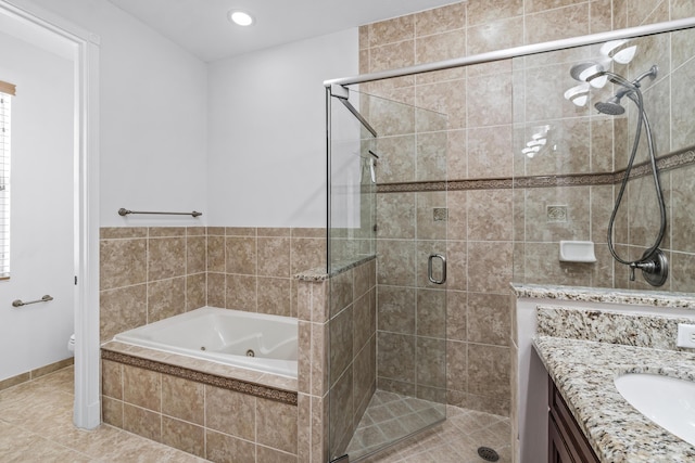 full bathroom featuring vanity, tile patterned floors, independent shower and bath, and toilet