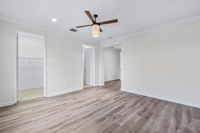 spare room featuring ornamental molding, ceiling fan, and light hardwood / wood-style flooring