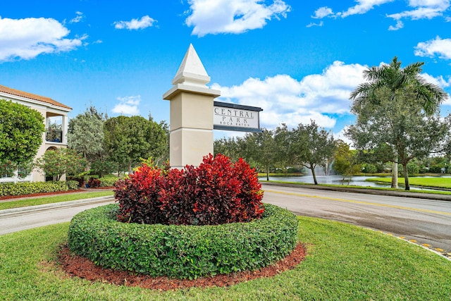 community / neighborhood sign featuring a water view