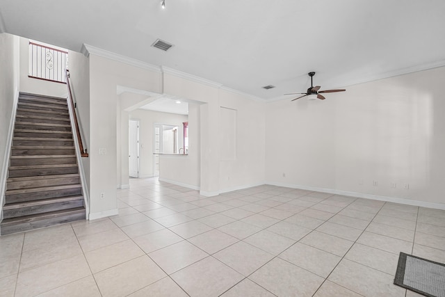 tiled spare room featuring crown molding and ceiling fan