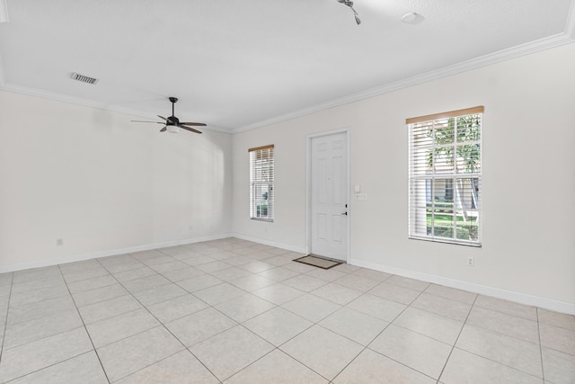 unfurnished room with ornamental molding and a healthy amount of sunlight